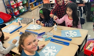  students creating snowflakes